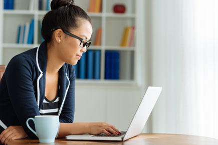 woman working at desk with laptop